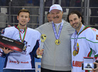 Alexander Lukashenko awards the tournament’s best defenseman Daniel Corso (Belarus)