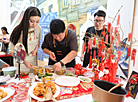 Participants of the Grace International beauty contest demonstrate cooking skills 